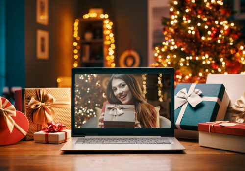 Woman,Videocalling,On,A,Laptop,And,Giving,A,Christmas,Gift,