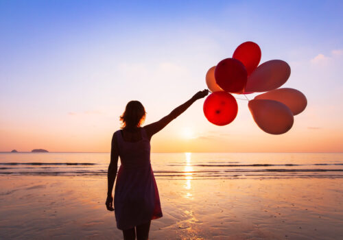 Imagination,And,Creativity,,Girl,With,Multicolored,Balloons,At,Sunset,With